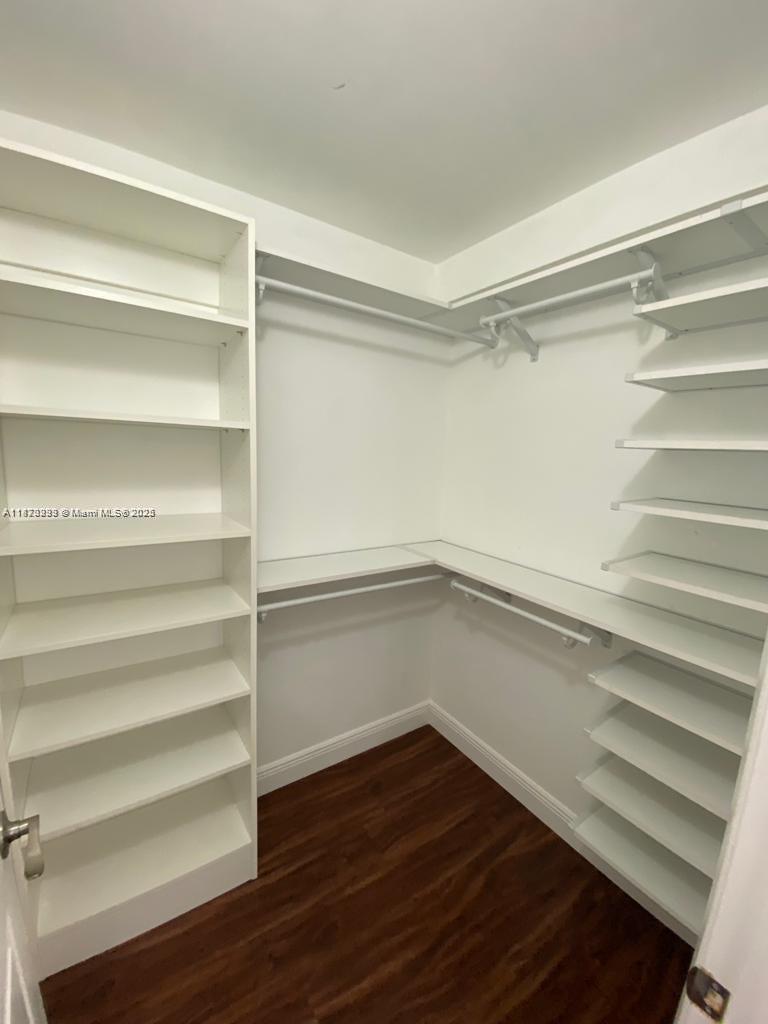 3259 Clint Moore Road, Unit 103 Boca Raton, FL 33496 - Photo 13 of 40 a view of walk in closet with empty racks