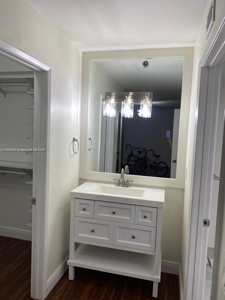 3259 Clint Moore Road, Unit 103 Boca Raton, FL 33496 - Photo 14 of 40 a bathroom with a double vanity sink and a mirror