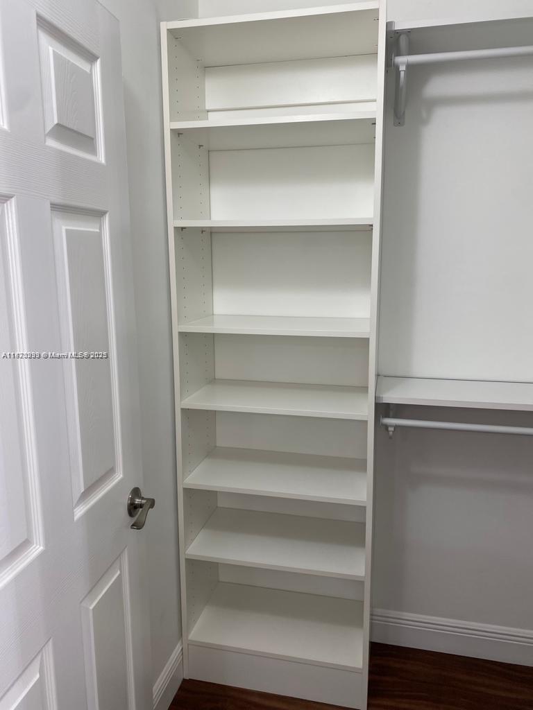 3259 Clint Moore Road, Unit 103 Boca Raton, FL 33496 - Photo 15 of 40 a view of walk in closet with empty racks