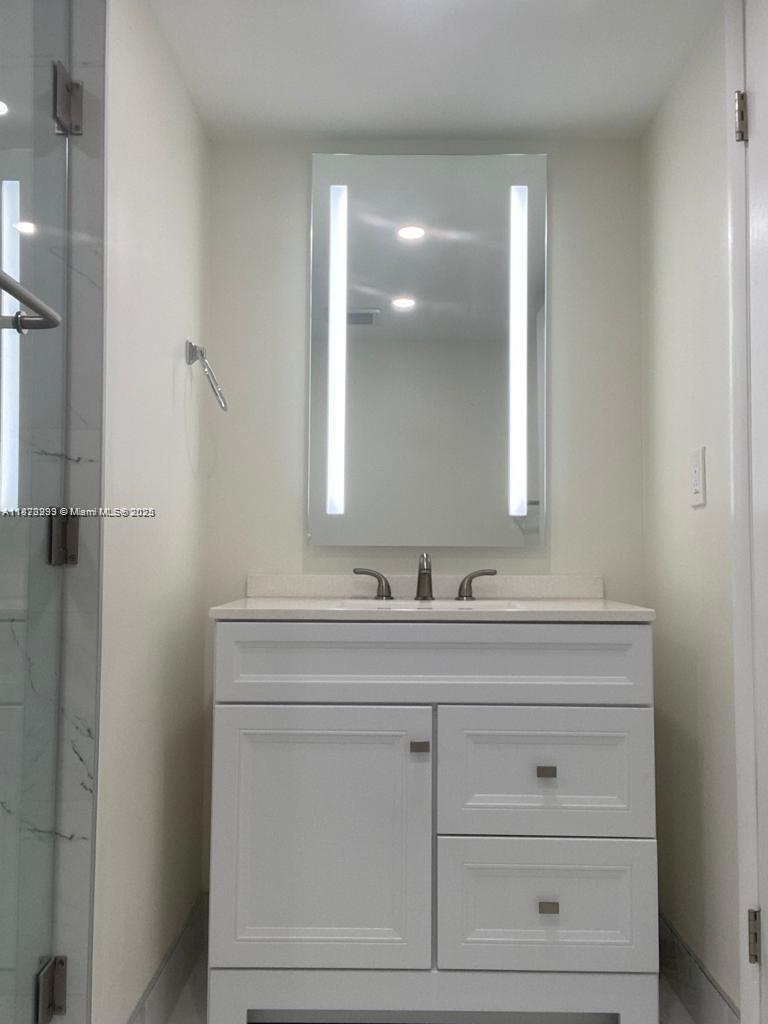 3259 Clint Moore Road, Unit 103 Boca Raton, FL 33496 - Photo 16 of 40 a bathroom with a sink and a mirror