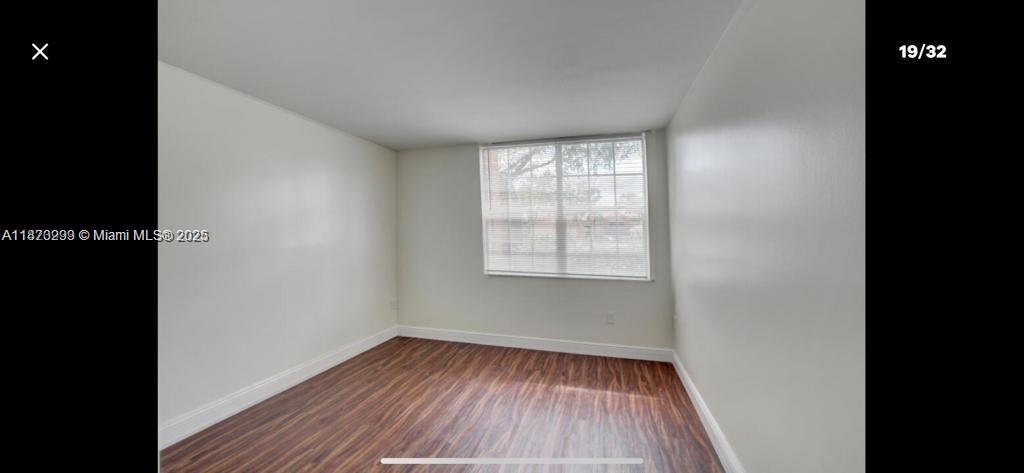 3259 Clint Moore Road, Unit 103 Boca Raton, FL 33496 - Photo 18 of 40 a view of a room with wooden floor and window