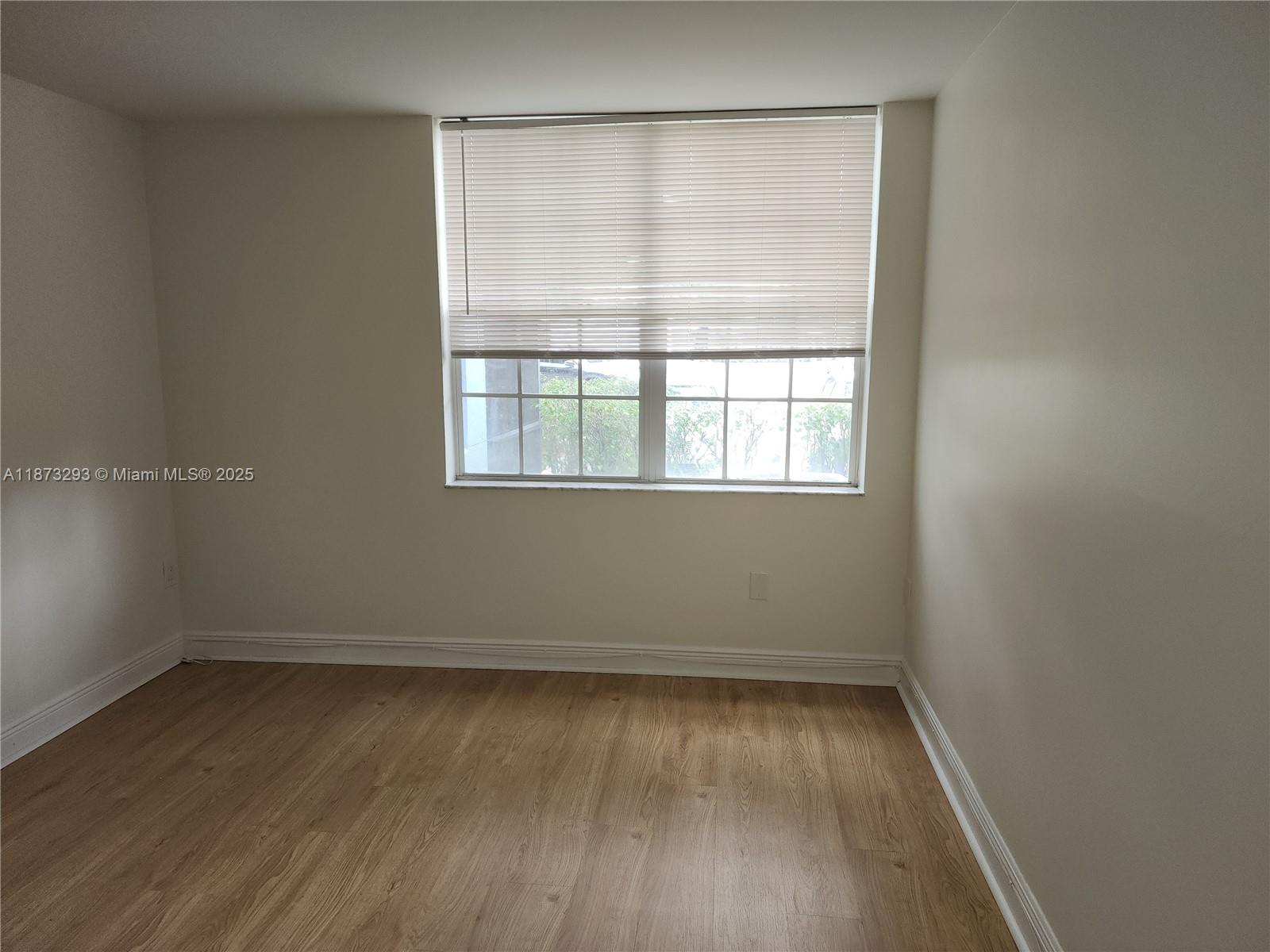 3259 Clint Moore Road, Unit 103 Boca Raton, FL 33496 - Photo 19 of 40 an empty room with a window