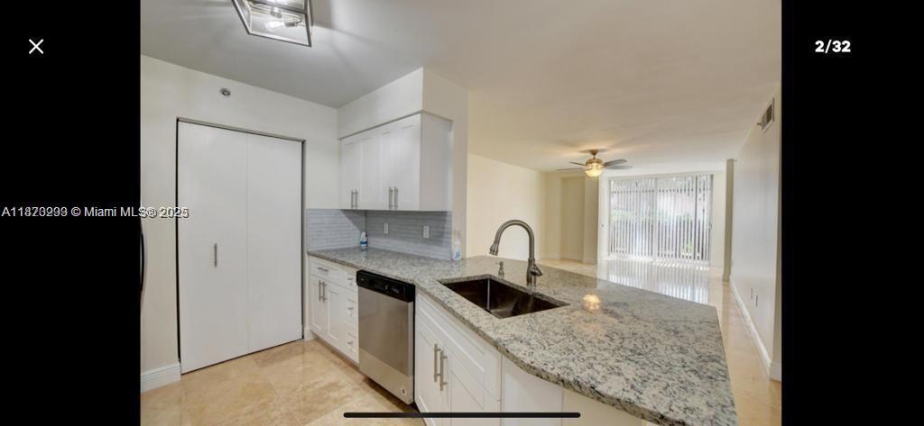 3259 Clint Moore Road, Unit 103 Boca Raton, FL 33496 - Photo 3 of 40 a kitchen with a sink a counter top space and appliances