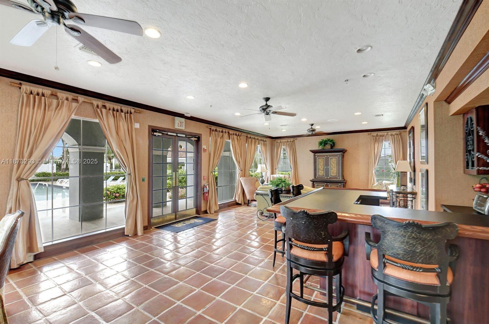3259 Clint Moore Road, Unit 103 Boca Raton, FL 33496 - Photo 35 of 40 a living room with fireplace furniture and a large window
