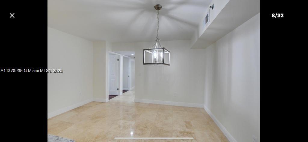3259 Clint Moore Road, Unit 103 Boca Raton, FL 33496 - Photo 6 of 40 a view of a hallway with a chandelier