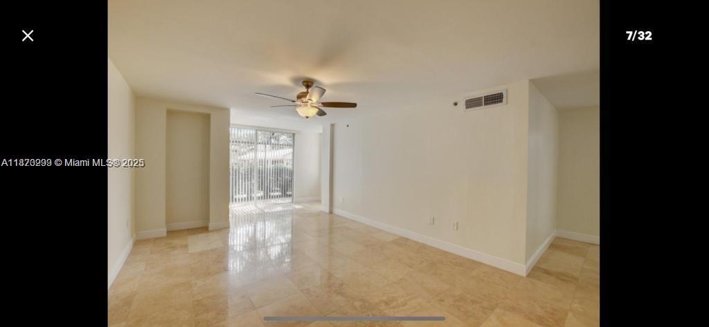 3259 Clint Moore Road, Unit 103 Boca Raton, FL 33496 - Photo 7 of 40 a view of an empty room with wooden floor and a bathroom