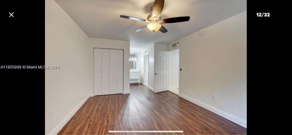 3259 Clint Moore Road, Unit 103 Boca Raton, FL 33496 - Photo 8 of 40 a view of an empty room with wooden floor