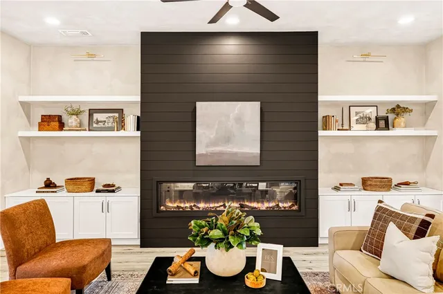 a living room with furniture kitchen view and a large window