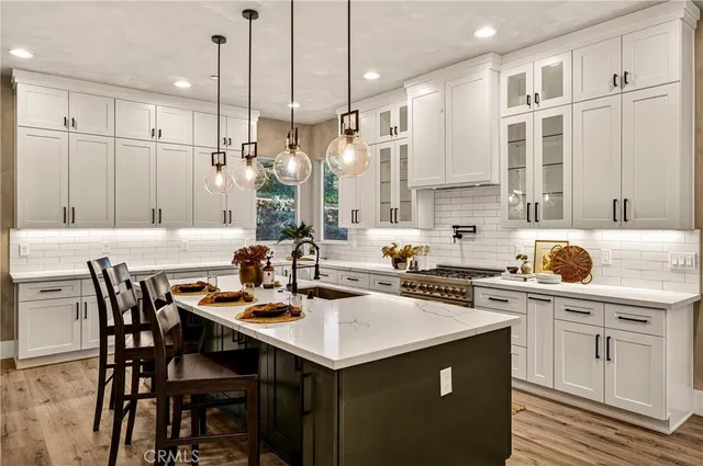 a kitchen with a refrigerator and a stove