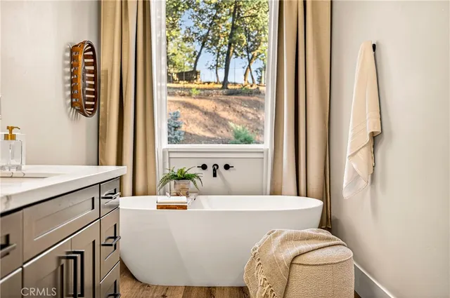 a bathroom with a sink a toilet a mirror and shower