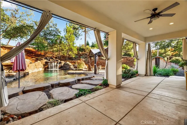 a view of a brick house with many windows and a yard