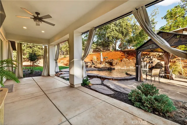 a backyard of a house with table and chairs