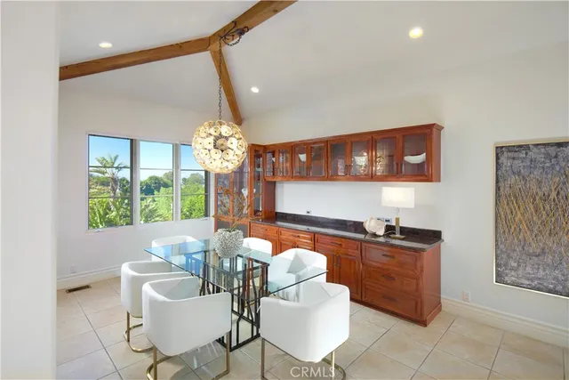a dining room with furniture a chandelier and a window