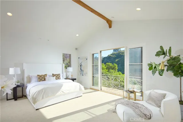 a spacious bedroom with a bed and a large window