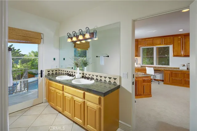 a spacious bathroom with a granite countertop sink and a mirror