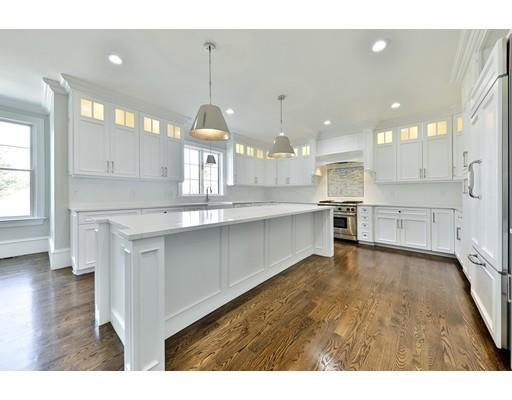 144 Schoolmasters Lane Dedham, MA 02026 - Photo 12 of 29 a open kitchen with kitchen island a sink stainless steel appliances and a fireplace