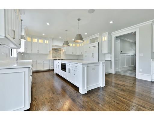 144 Schoolmasters Lane Dedham, MA 02026 - Photo 10 of 29 a large kitchen with kitchen island a stove a sink dishwasher and white cabinets with wooden floor