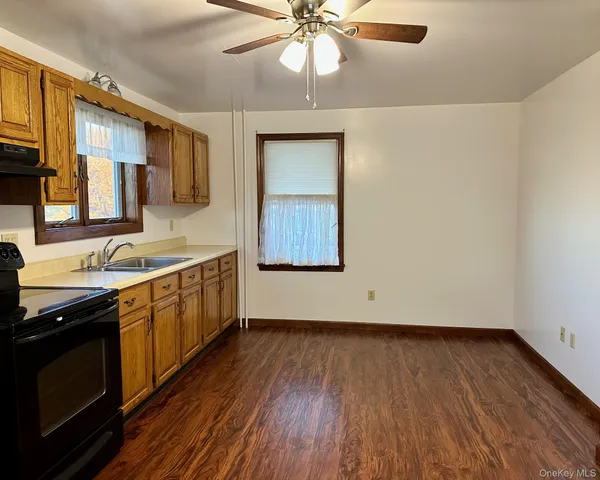 a view of kitchen with sink and wooden floor