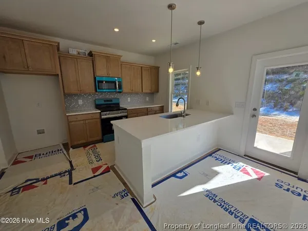 a living room with a rug and a table