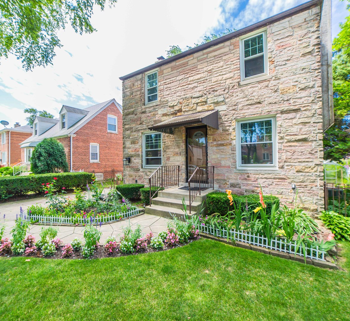 1924 Linden Avenue Park Ridge, IL 60068 - Photo 2 of 28 a front view of a house with a garden and plants