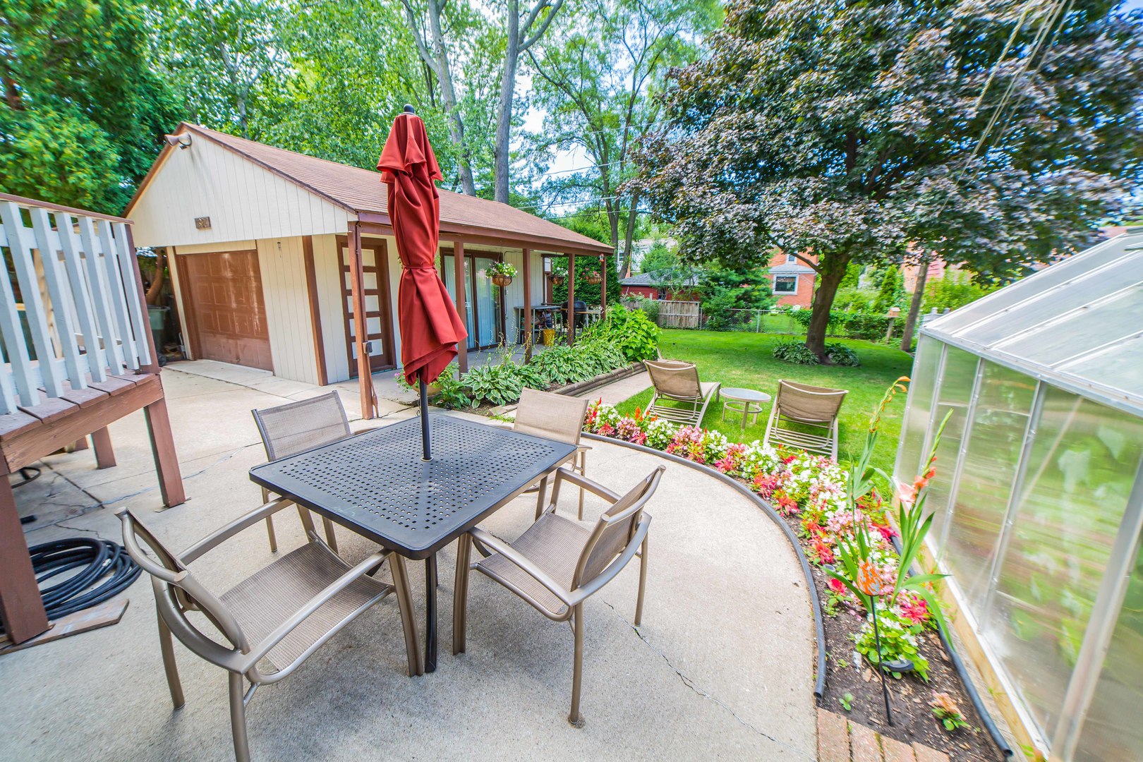 1924 Linden Avenue Park Ridge, IL 60068 - Photo 27 of 28 a view of a patio with table and chairs a barbeque with wooden fence and plants