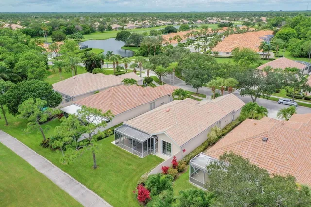 an aerial view of house with yard and swimming pool
