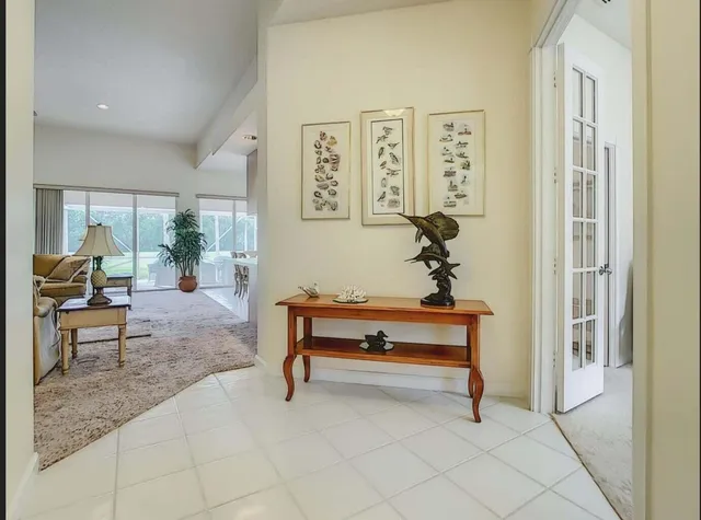 a view of a dining room with furniture and a chandelier