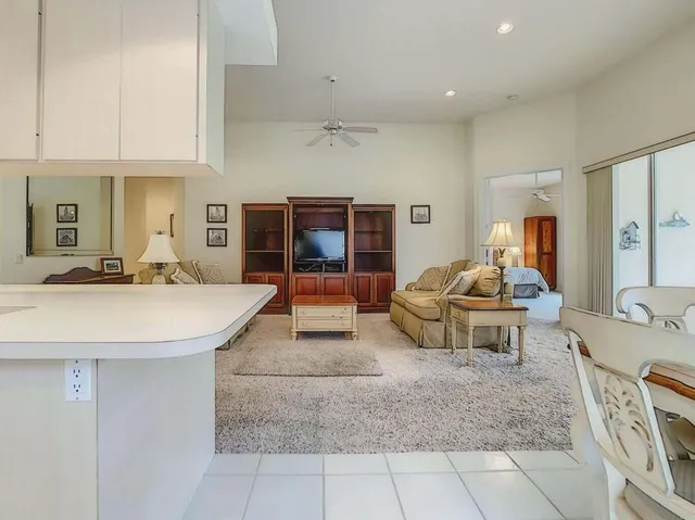 a dining room with furniture a chandelier and wooden floor