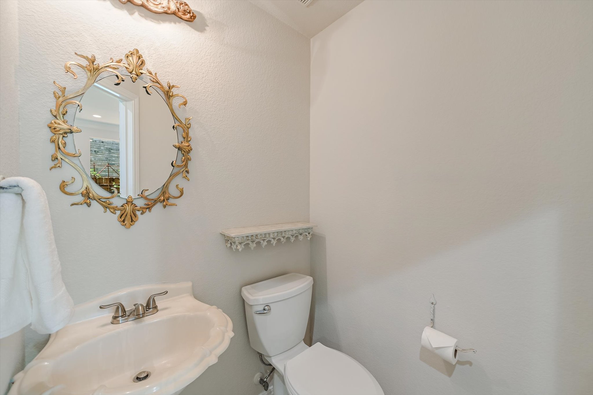 2849 Grimes Ranch Road Austin, TX 78732 - Photo 14 of 31 A graceful pedestal sink and toilet create a tidy powder room for guests.