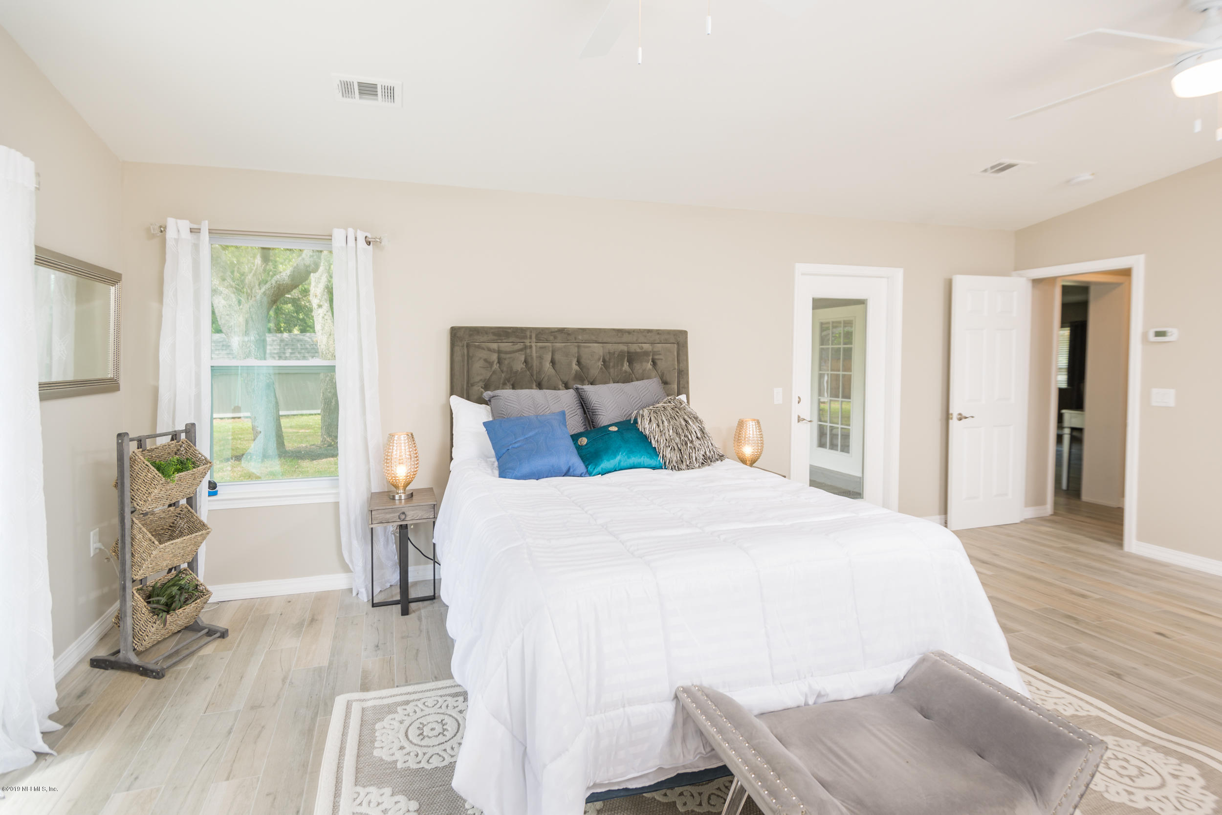 130 Tanager Road St. Augustine, FL 32086 - Photo 23 of 63 a bedroom with a bed and wooden floor