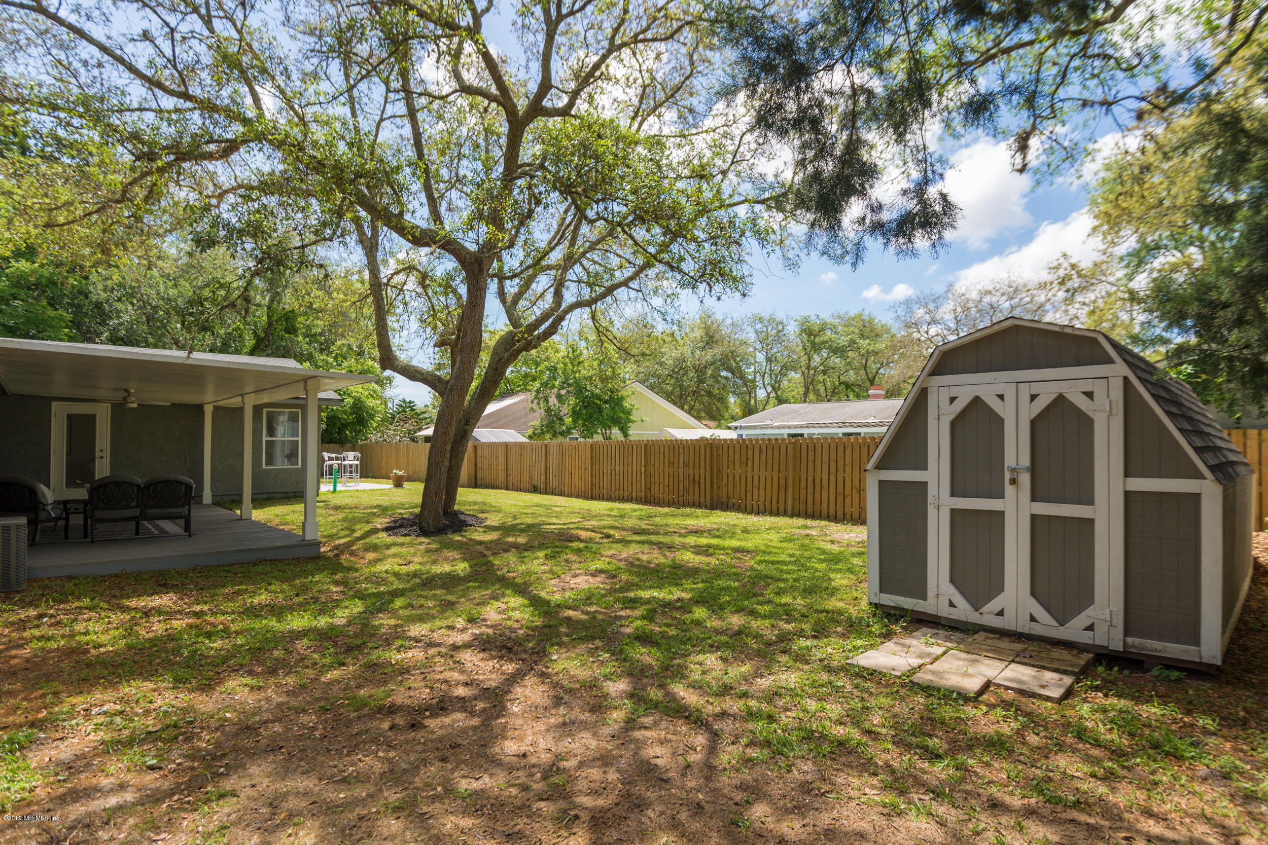 130 Tanager Road St. Augustine, FL 32086 - Photo 54 of 63 a backyard of a house with yard and outdoor seating