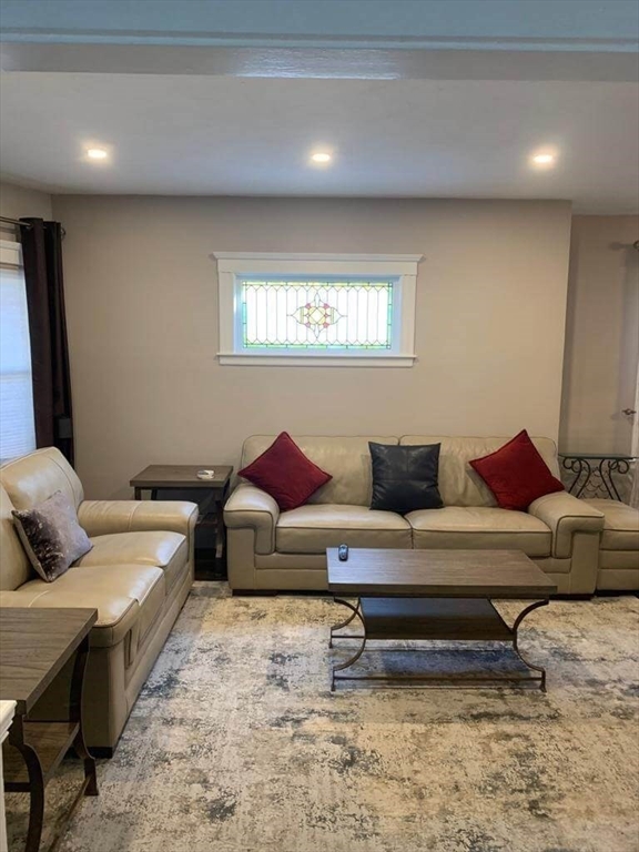348 School Street, Unit 348 Watertown, MA 02472 - Photo 2 of 15 a living room with furniture and a rug