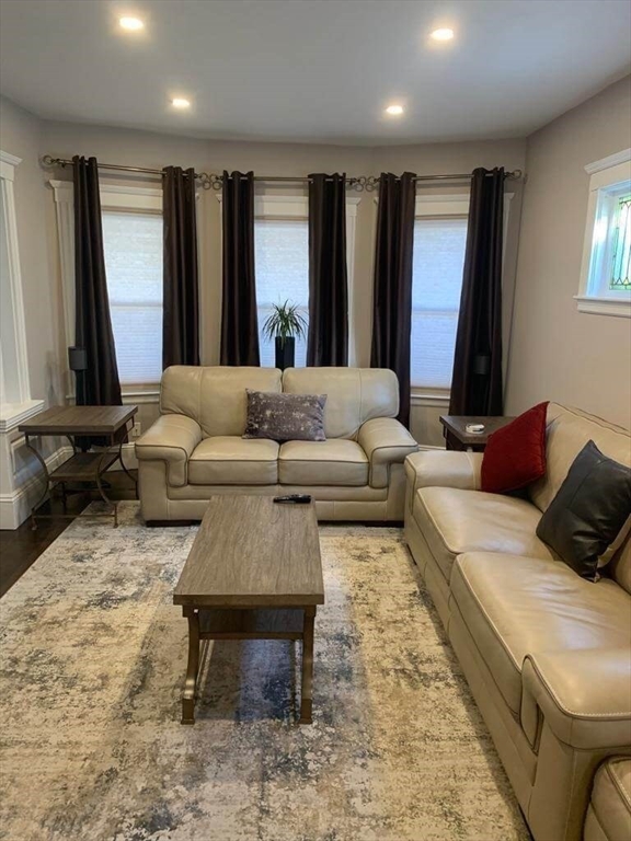 348 School Street, Unit 348 Watertown, MA 02472 - Photo 3 of 15 a living room with furniture and a rug