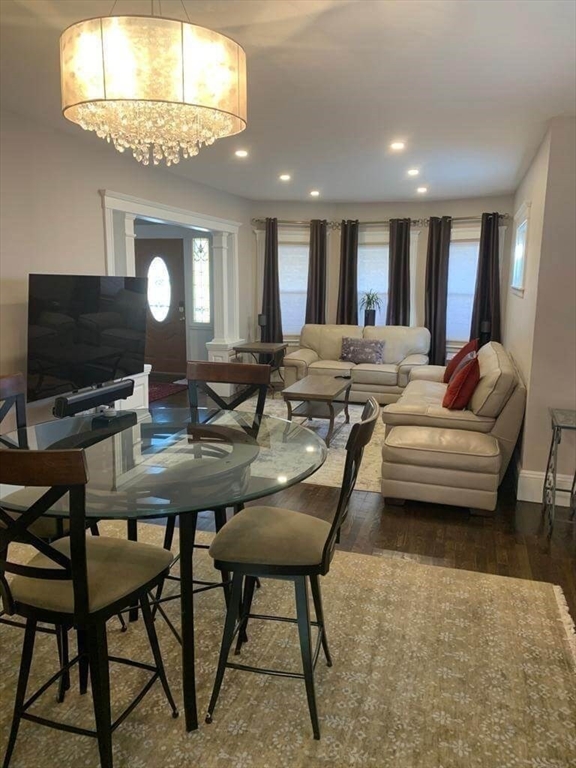 348 School Street, Unit 348 Watertown, MA 02472 - Photo 5 of 15 a living room with furniture and a flat screen tv