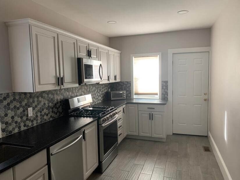 348 School Street, Unit 348 Watertown, MA 02472 - Photo 8 of 15 a kitchen with a sink stove and microwave