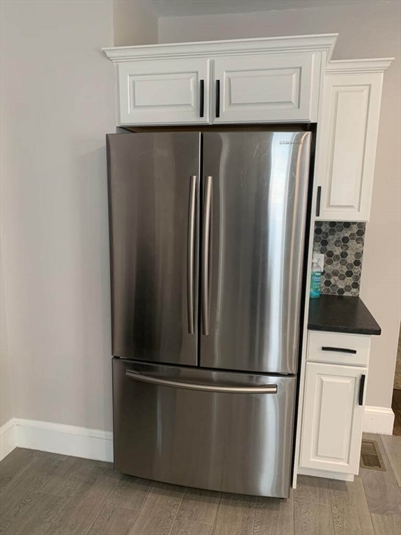 348 School Street, Unit 348 Watertown, MA 02472 - Photo 9 of 15 a metallic refrigerator freezer sitting in a kitchen