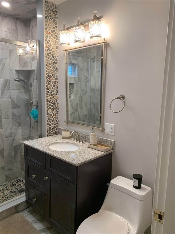 348 School Street, Unit 348 Watertown, MA 02472 - Photo 10 of 15 a bathroom with a sink and a mirror