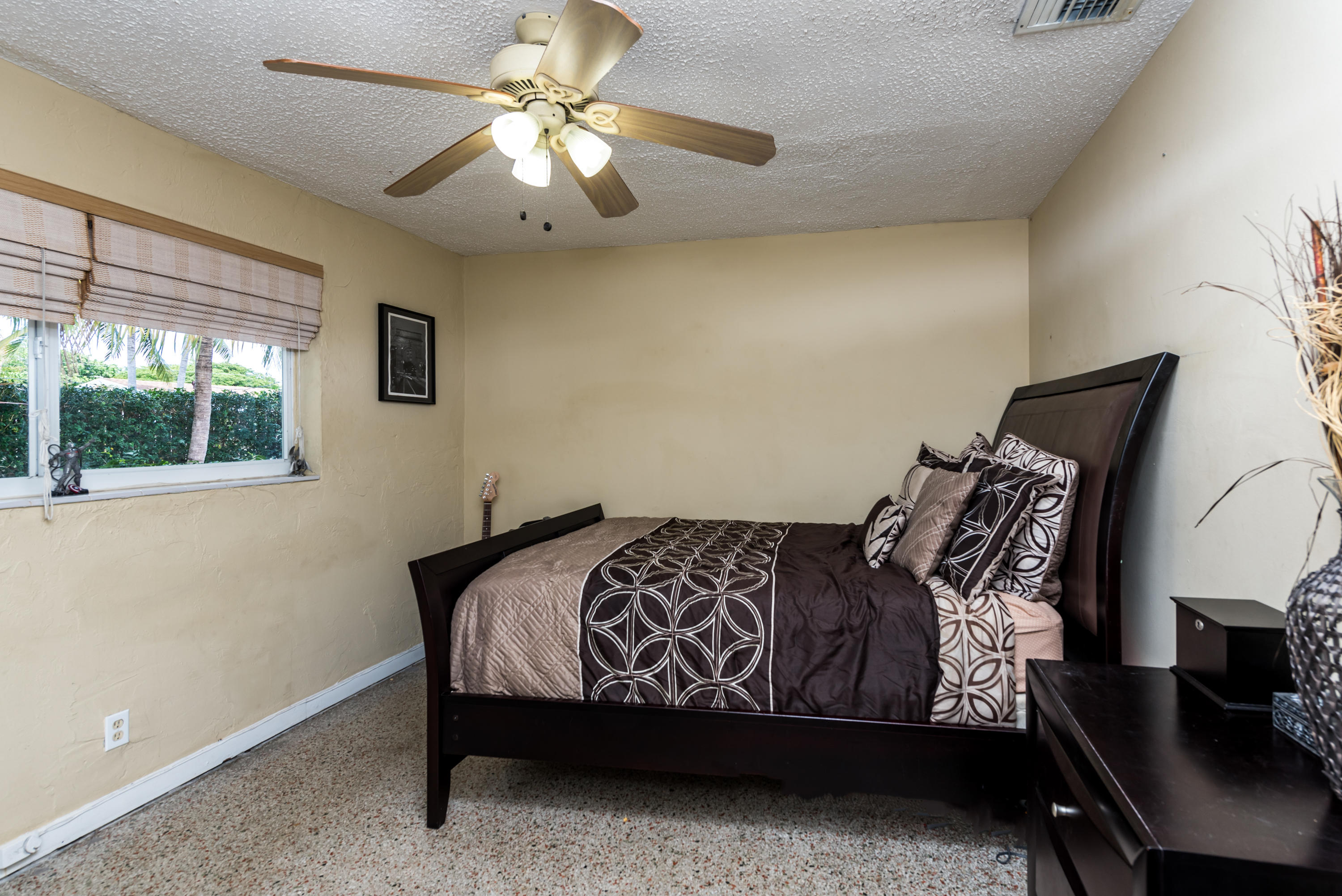 455 Northeast 37th Street Boca Raton, FL 33431 - Photo 11 of 19 a bed sitting in a bedroom next to a window