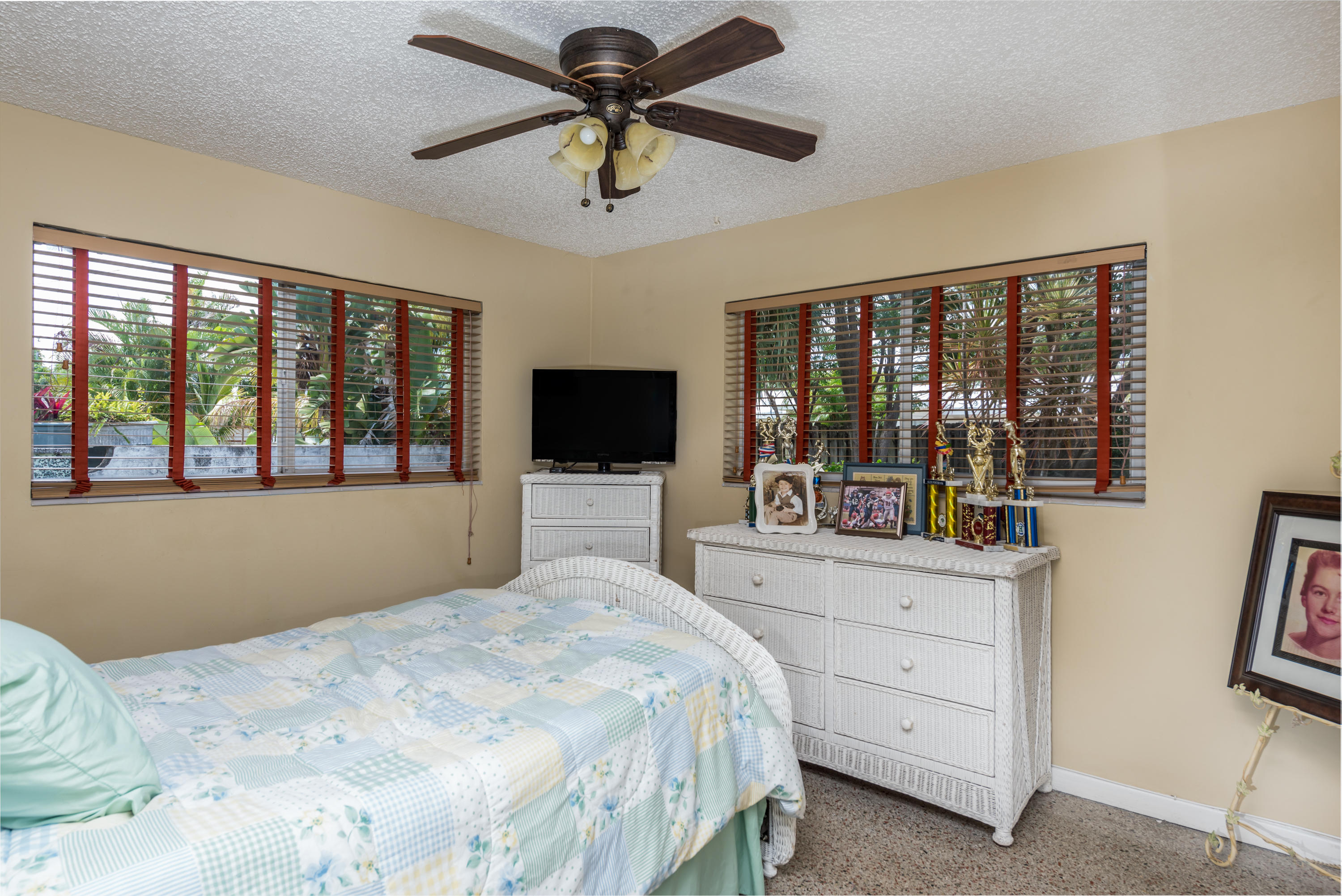 455 Northeast 37th Street Boca Raton, FL 33431 - Photo 13 of 19 a bedroom with a large bed and a flat tv screen on dresser