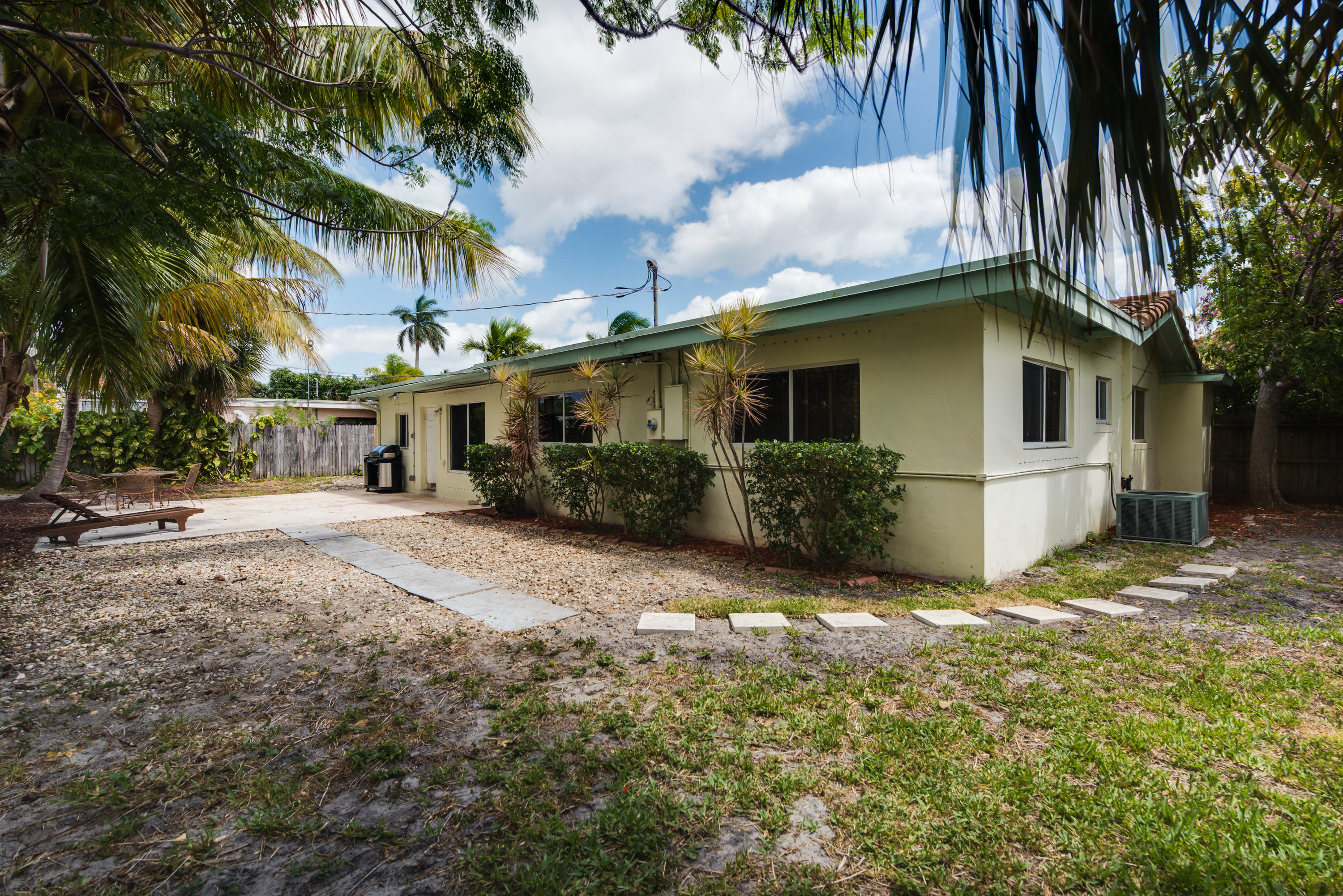 455 Northeast 37th Street Boca Raton, FL 33431 - Photo 17 of 19 a view of a house with a yard and palm trees