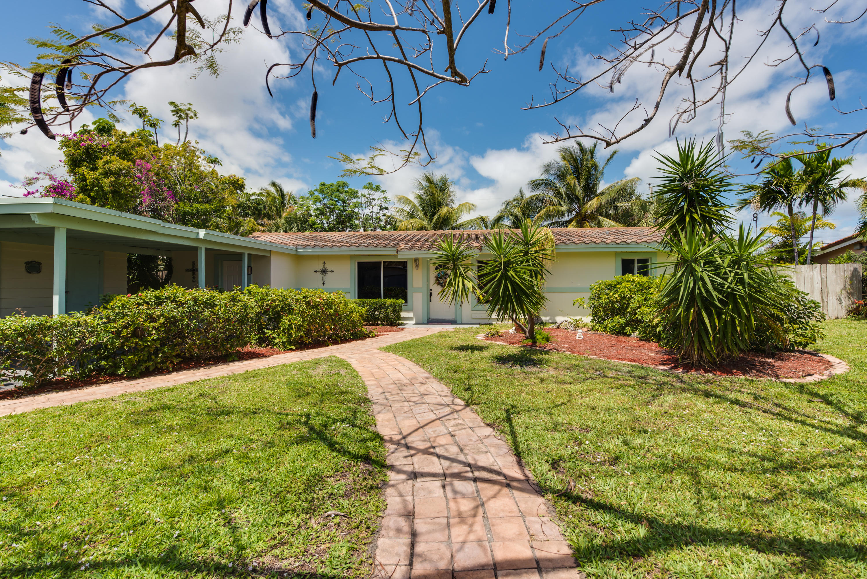 455 Northeast 37th Street Boca Raton, FL 33431 - Photo 18 of 19 a view of a house with a yard and potted plants