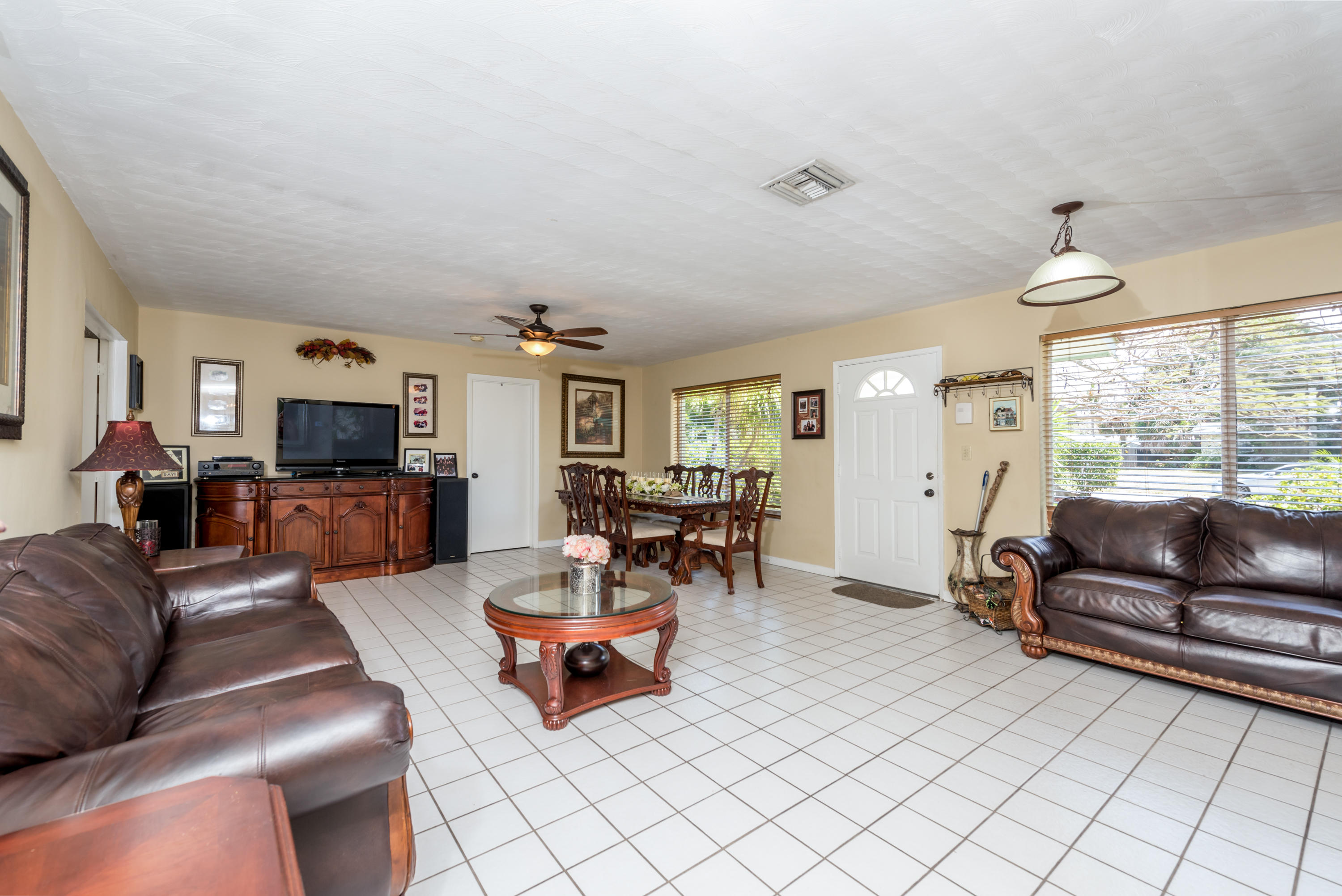 455 Northeast 37th Street Boca Raton, FL 33431 - Photo 3 of 19 a living room with furniture and a flat screen tv
