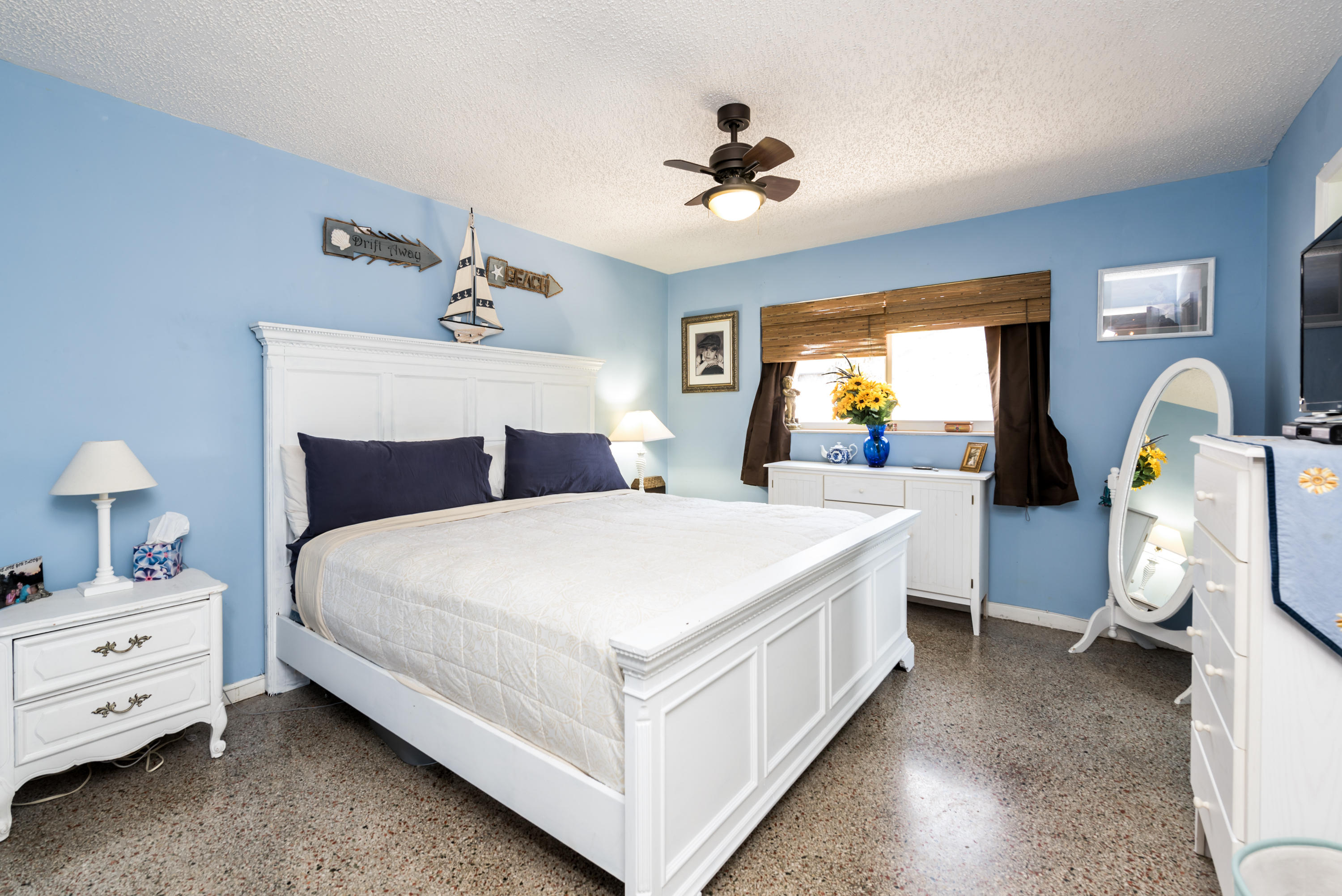 455 Northeast 37th Street Boca Raton, FL 33431 - Photo 7 of 19 a bedroom with a bed and a chandelier