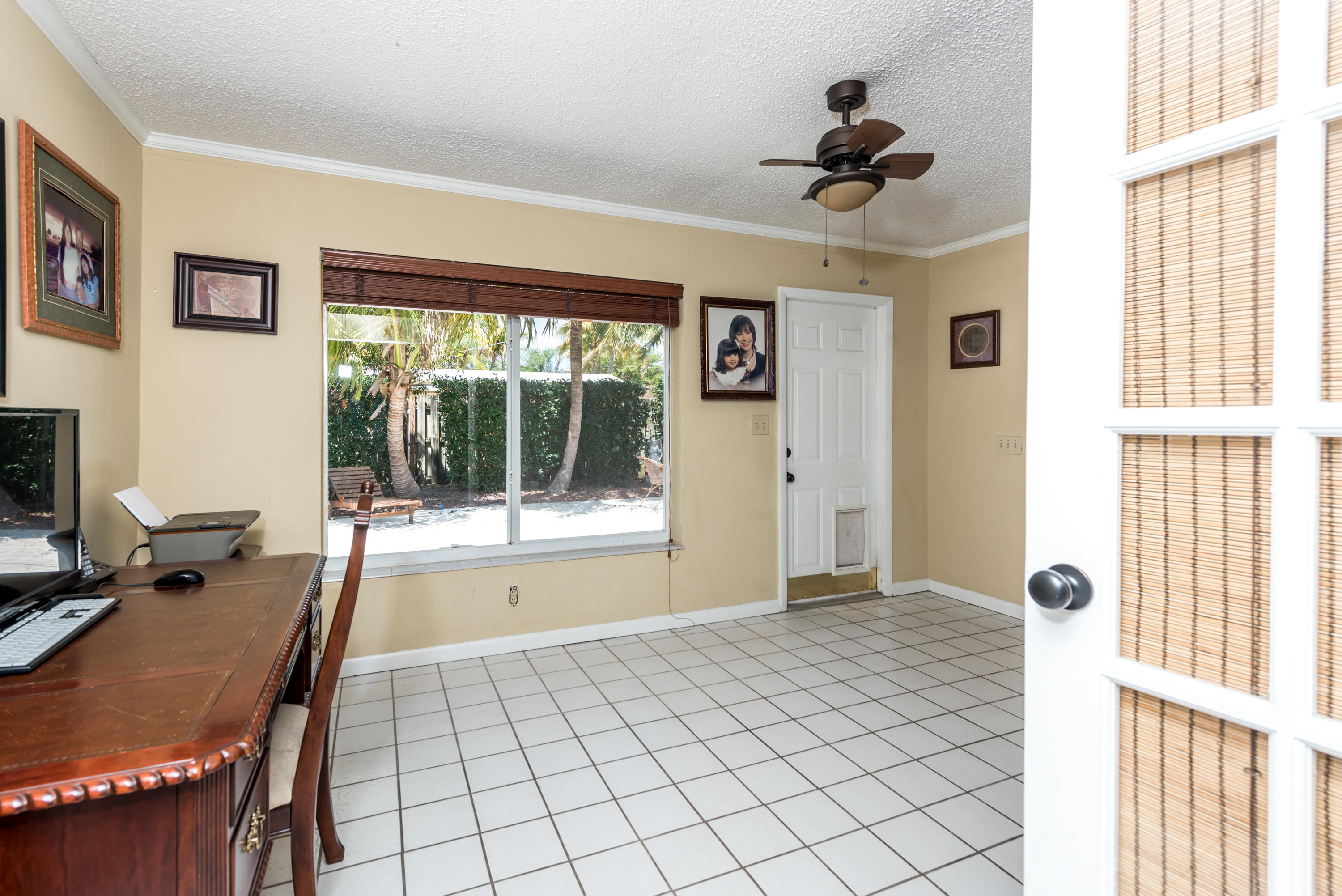 455 Northeast 37th Street Boca Raton, FL 33431 - Photo 9 of 19 a view of a workspace with furniture and a window