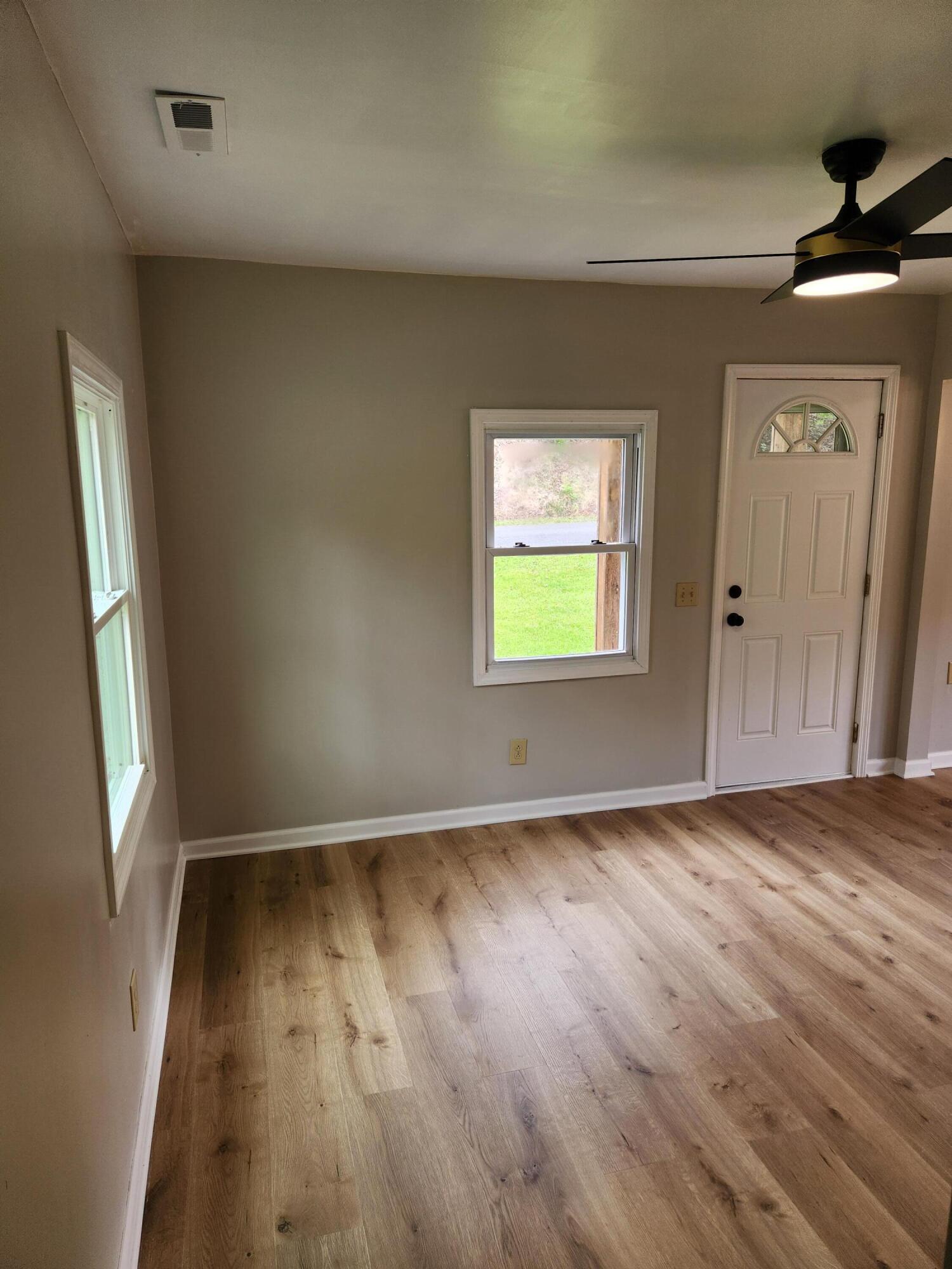 101 Union Road Ferrum, VA 24088 - Photo 13 of 41 an empty room with wooden floor and windows