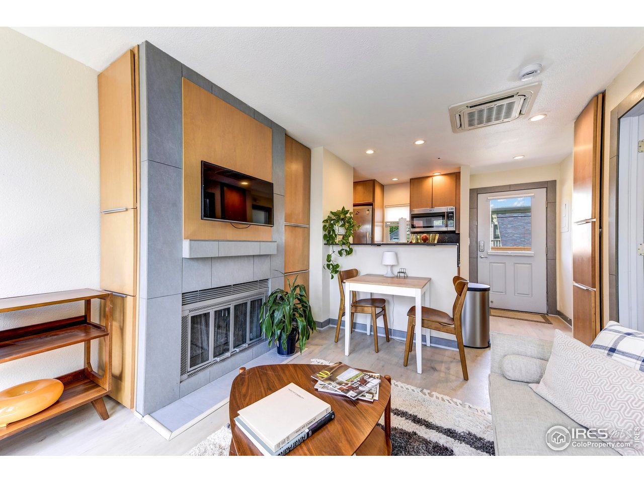 3025 Broadway, Unit 10 Boulder, CO 80304 - Photo 1 of 20 a living room with stainless steel appliances furniture a rug and a kitchen view
