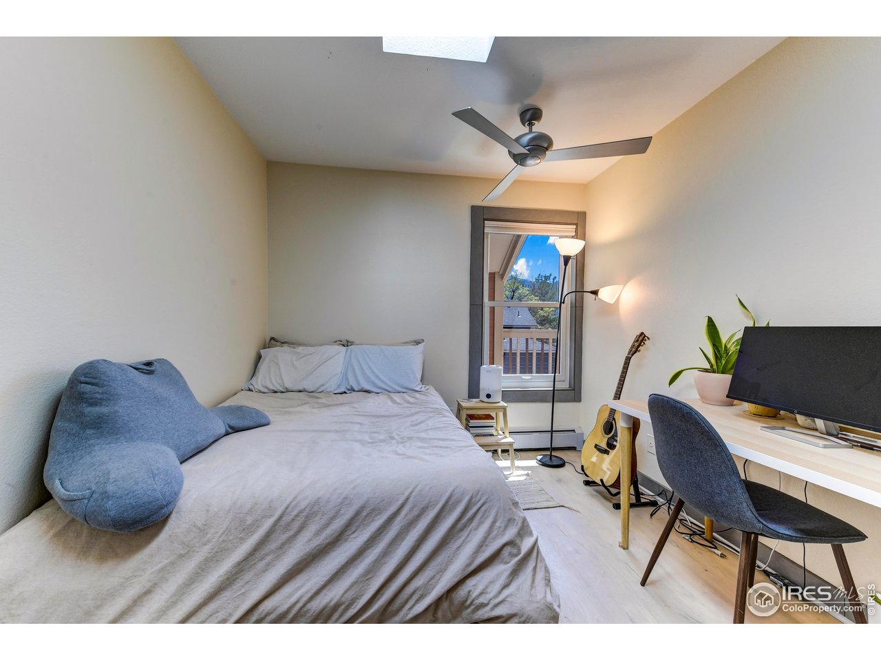 3025 Broadway, Unit 10 Boulder, CO 80304 - Photo 9 of 20 a bedroom with a bed a desk and chair
