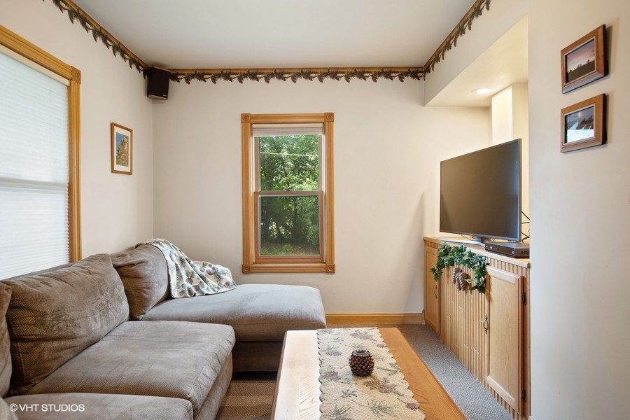8808 Bard Road Crystal Lake, IL 60014 - Photo 18 of 32 a living room with furniture and a flat screen tv