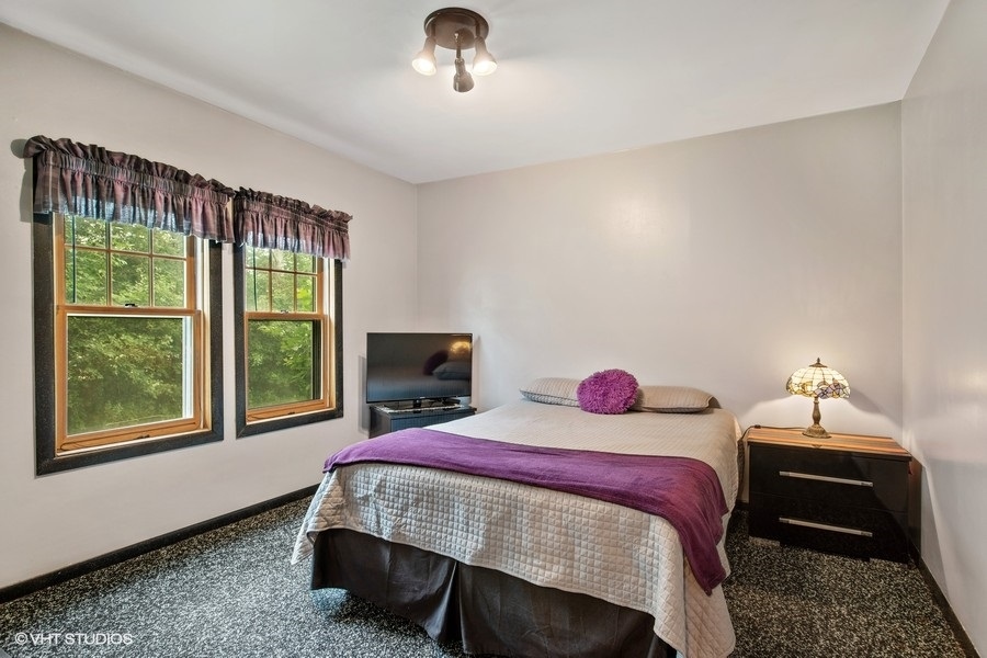 8808 Bard Road Crystal Lake, IL 60014 - Photo 20 of 32 a bedroom with a bed and window