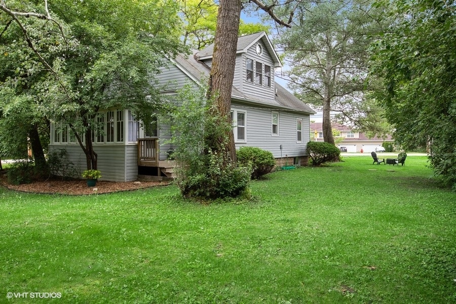 8808 Bard Road Crystal Lake, IL 60014 - Photo 27 of 32 a view of a house with a yard and tree
